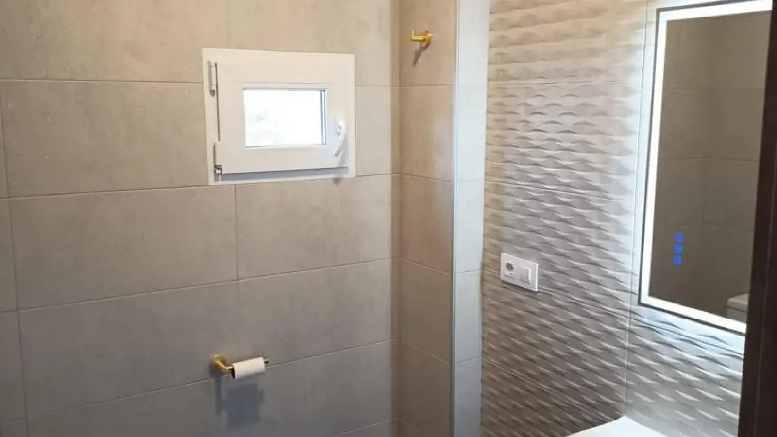 Baño reformado con mueble y revestimientos claros